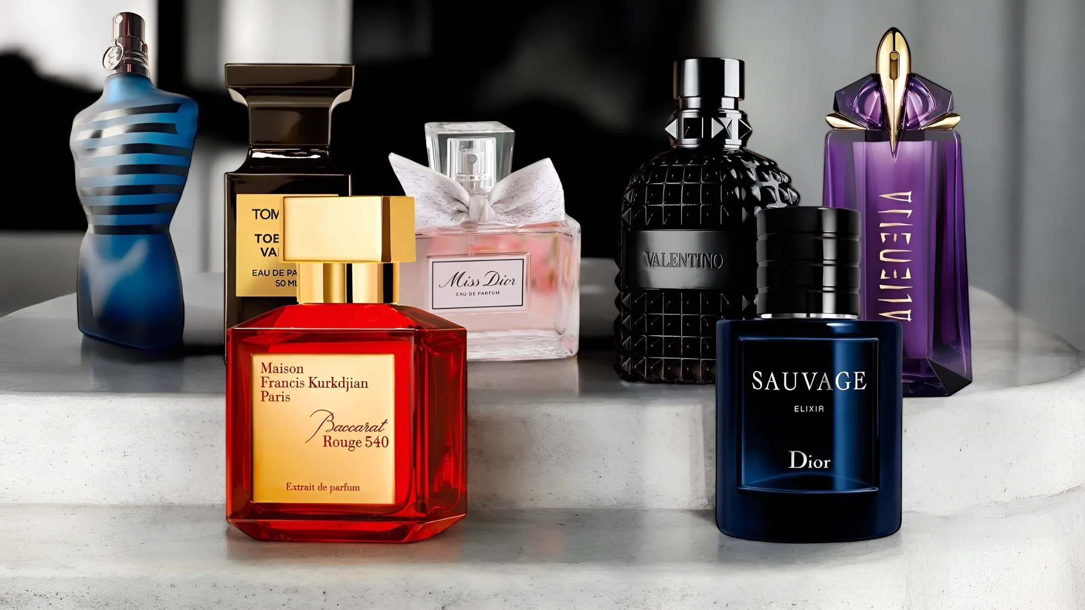 A curated shelf of the world's great fragrances on marble